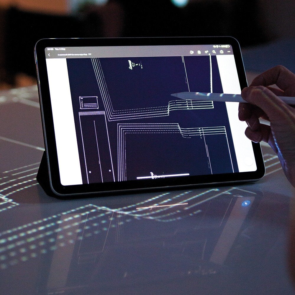 Digital sewing pattern PDF displayed on a tablet for projector cutting setup.